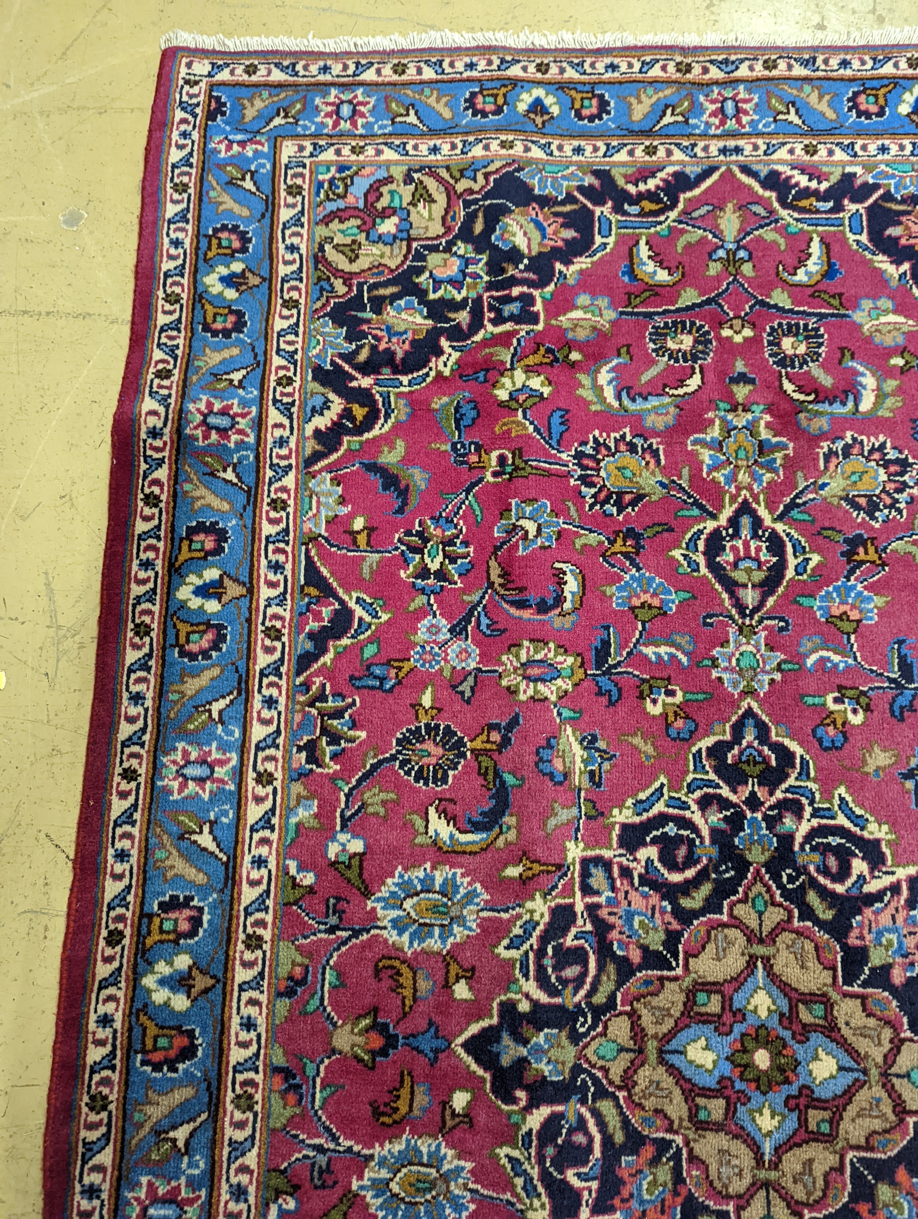 A Najaf Abad claret ground rug, 200 x 114cm